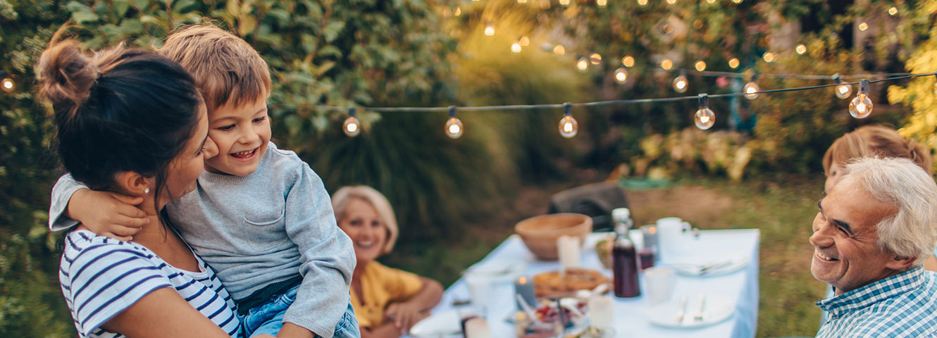 Family eating dinner in backyard.